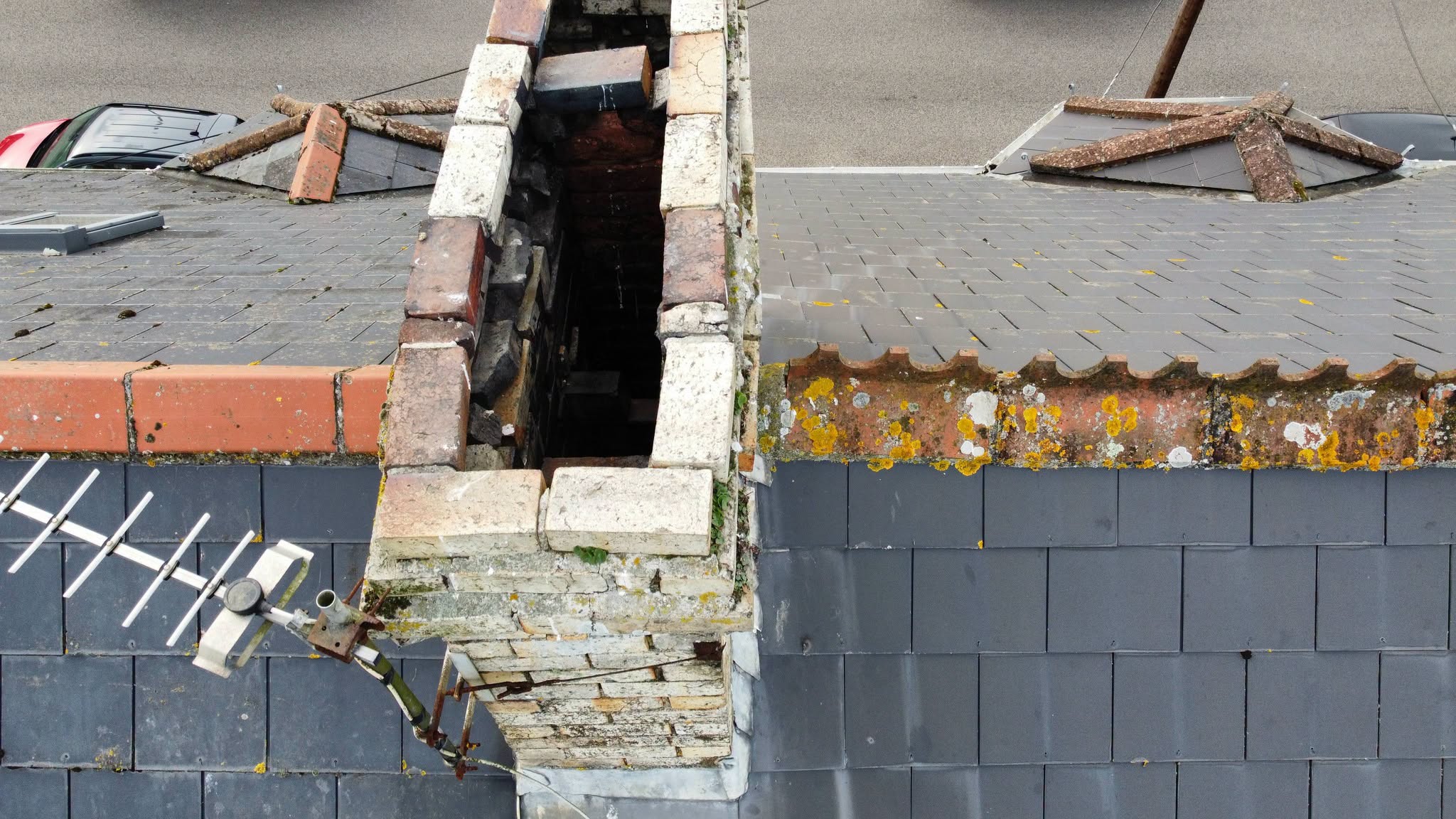 The same chimney stack from the side, slate roof and ridge tiles below